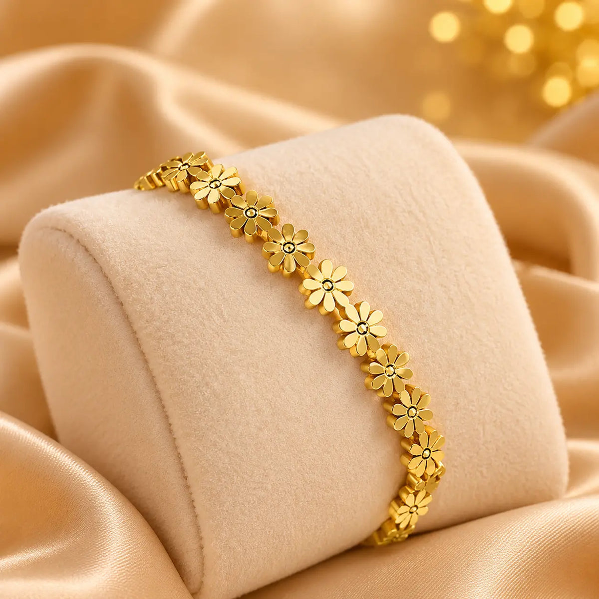 Gold-tone daisy flower bracelet on a cream bracelet stand
