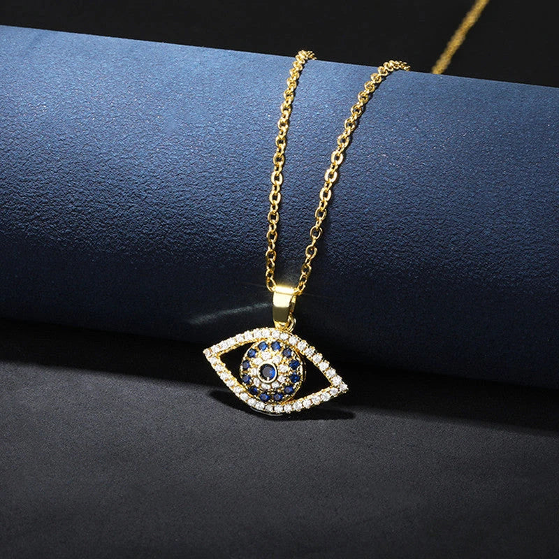 Evil eye pendant necklace draped over a navy display