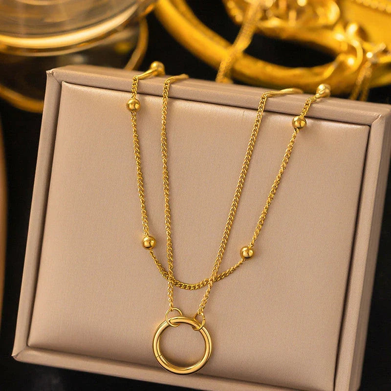 Double layer hoop necklace on a beige jewellery box