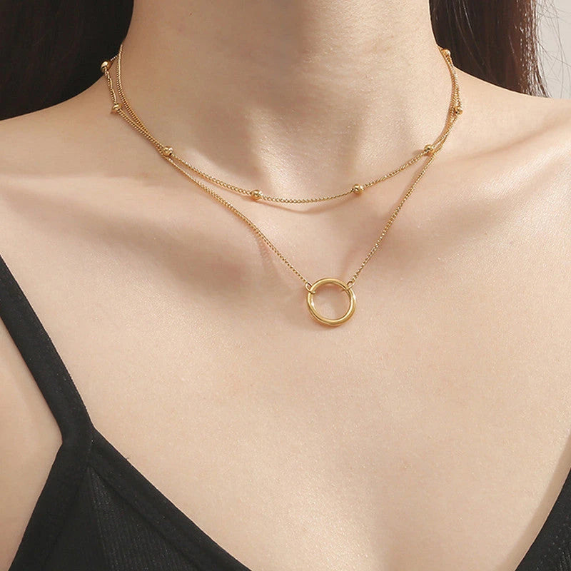 Double layer necklace worn with a black strap top