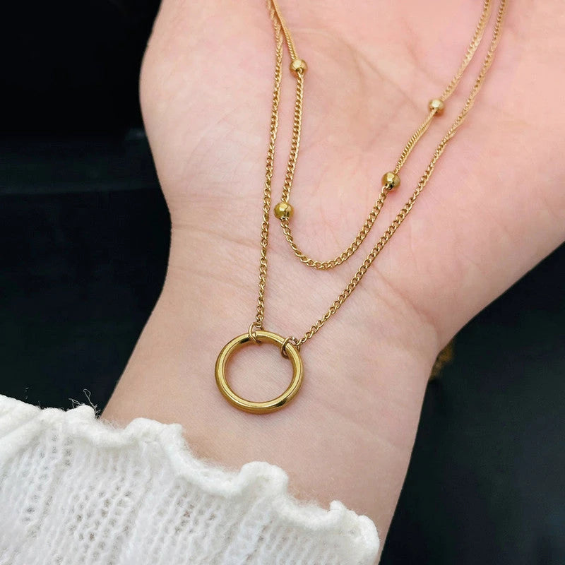 Hoop necklace held in the hand to show its size