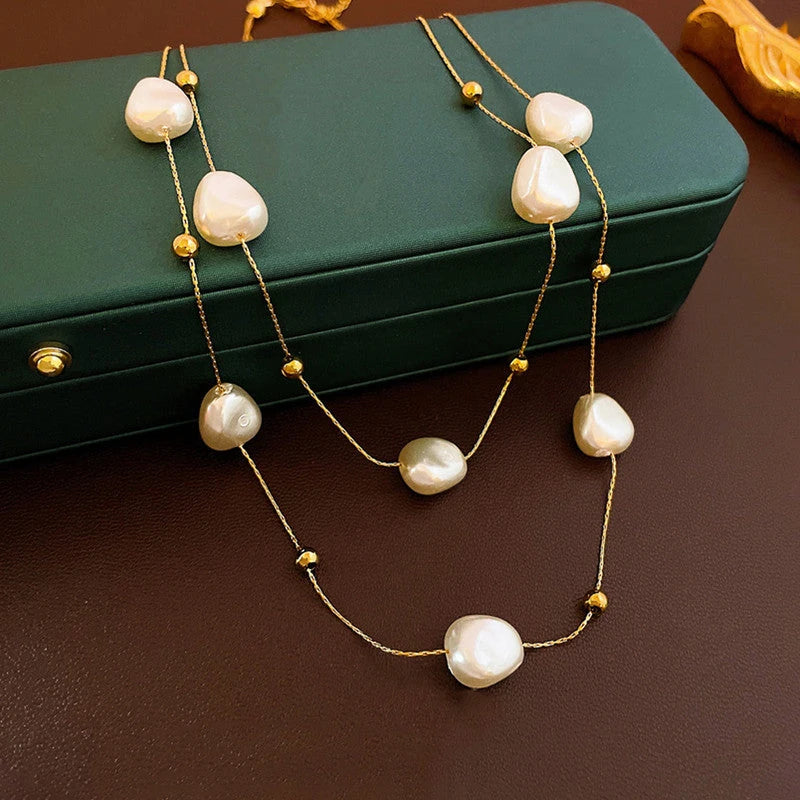 Layered pearl necklace on a green jewellery box