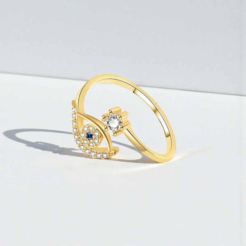 Evil eye ring standing on a white surface with its shadow