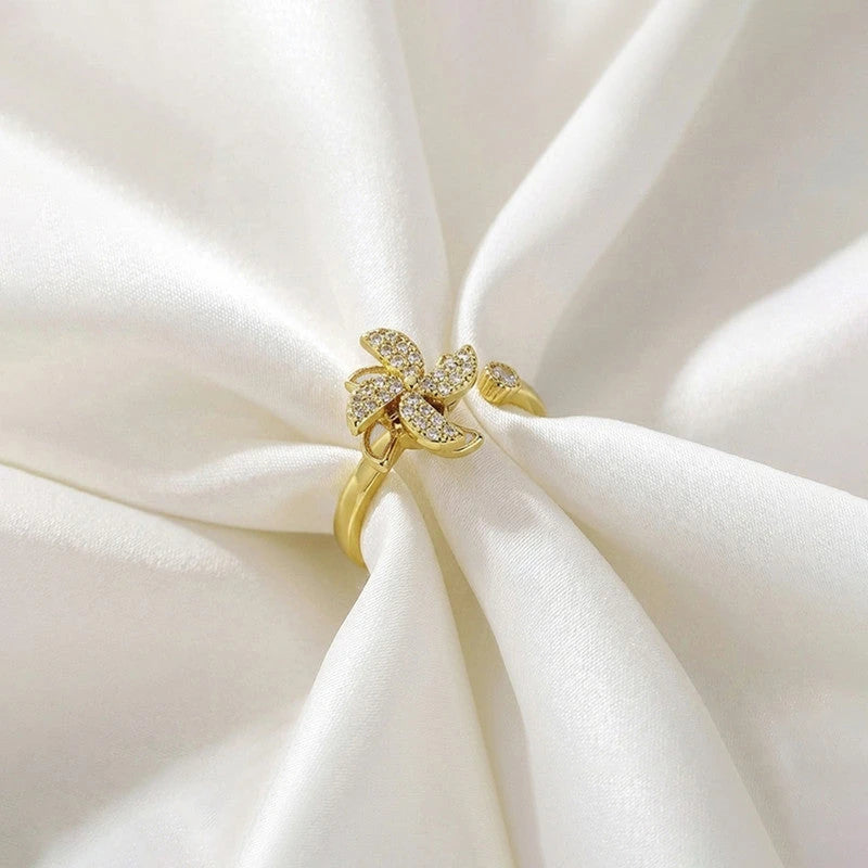 Pinwheel ring resting on folded white silk