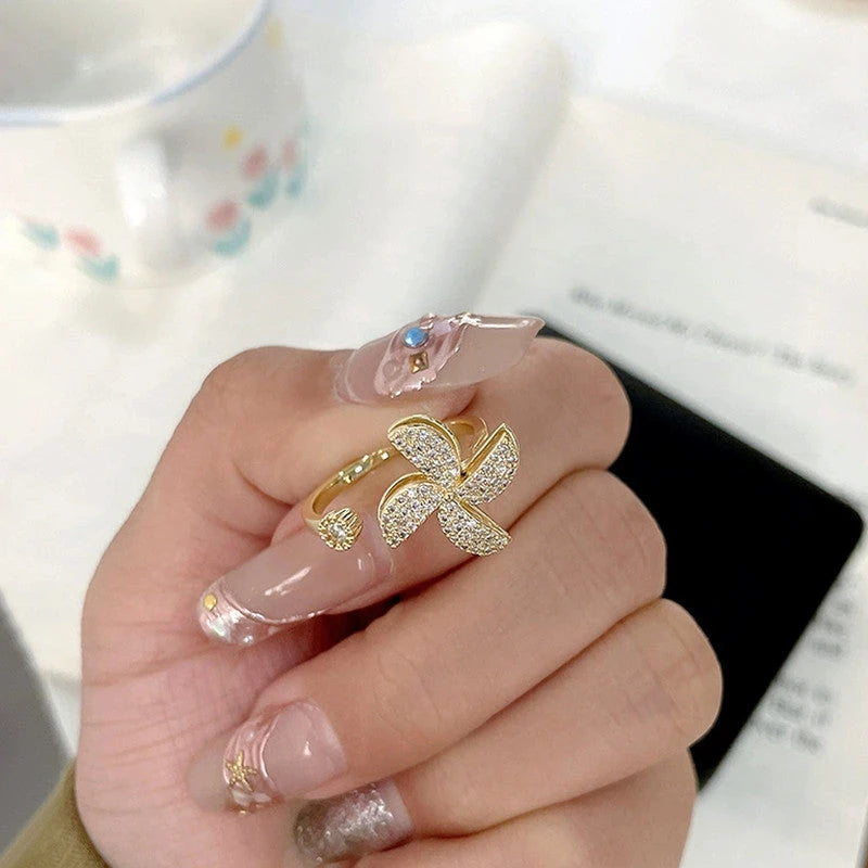 Close-up of the pinwheel ring worn on the index finger