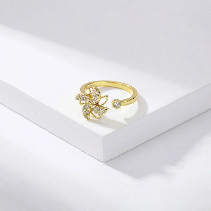Open adjustable band of the pinwheel ring on a white block