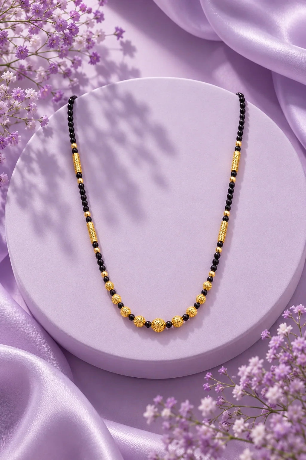 Black bead mangalsutra on a lilac display