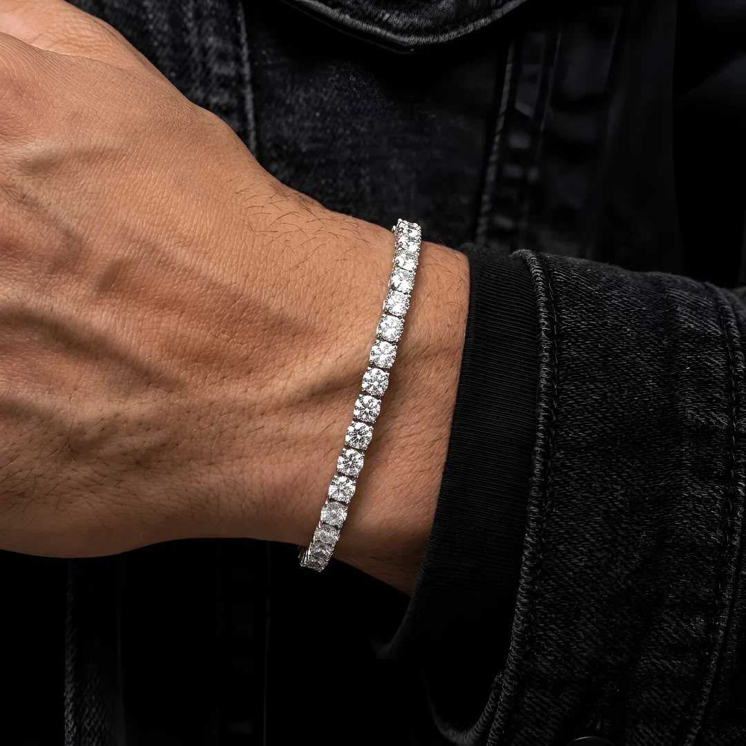 Silver-tone CZ tennis bracelet worn on a man's wrist